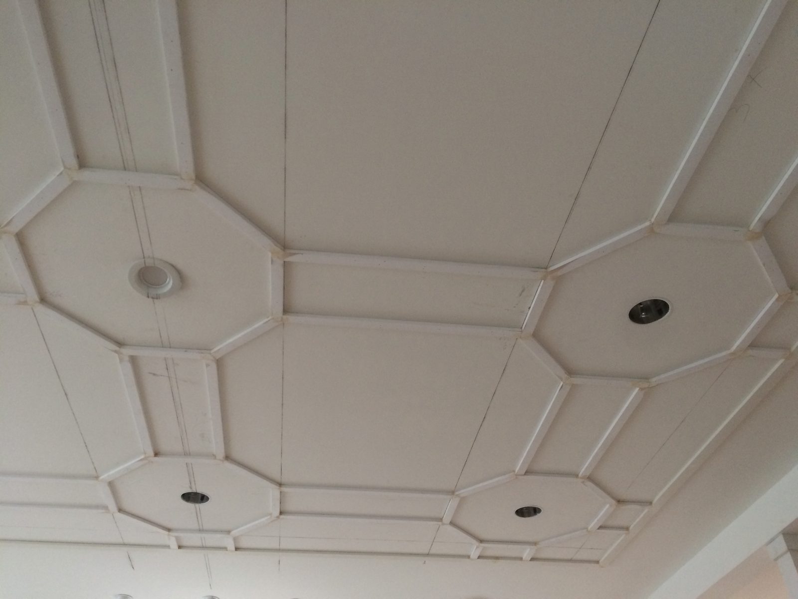 Paneled ceiling before paint: octagons around the recessed lights joined by rectangles, with pencil layout lines still visible.